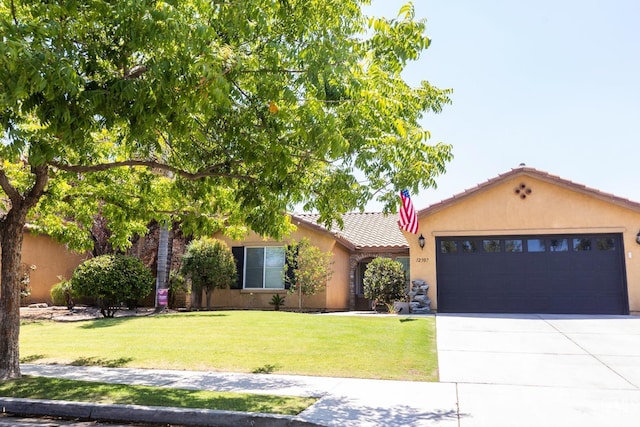 view of front of home with a garage and a front yard