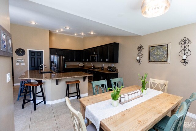 dining space with light tile patterned floors and sink