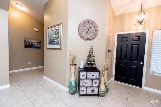 foyer with an inviting chandelier and light tile patterned flooring