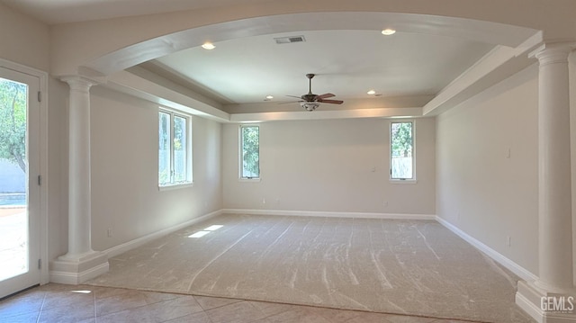 3006 Springbank Ct, Bakersfield, CA 93311 - spare room featuring ornate columns, a ceiling fan, a tray ceiling, light carpet, and arched walkways