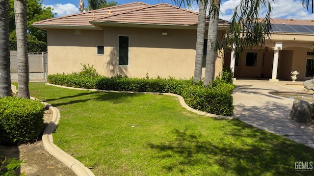 3006 Springbank Ct, Bakersfield, CA 93311 - rear view of property featuring stucco siding, a patio, a tile roof, and roof mounted solar panels