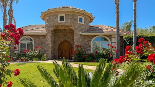 3006 Springbank Ct, Bakersfield, CA 93311 - view of front of home featuring a tile roof, stone siding, and a front lawn