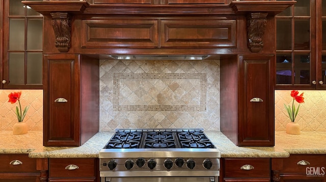 3006 Springbank Ct, Bakersfield, CA 93311 - kitchen with high end stove, tasteful backsplash, glass insert cabinets, and light stone counters