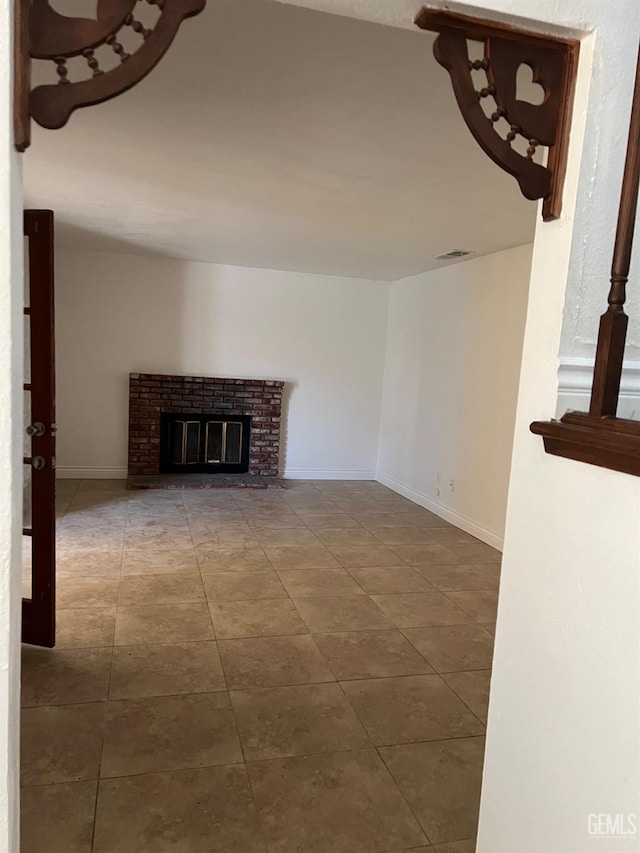 unfurnished living room with a brick fireplace