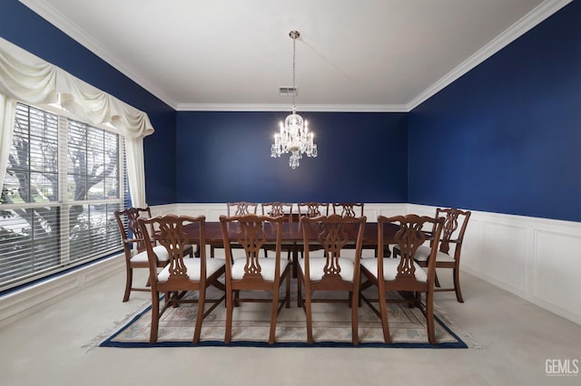 carpeted dining room featuring an inviting chandelier and ornamental molding