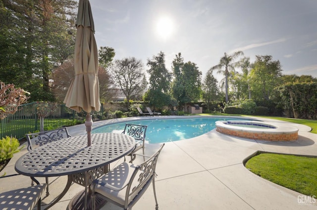 view of swimming pool with a patio and an in ground hot tub