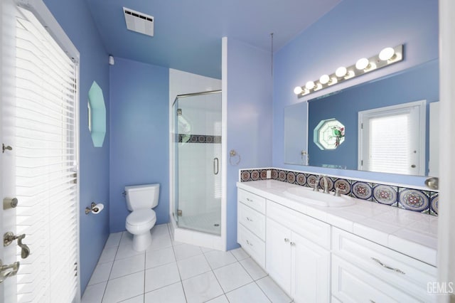 bathroom featuring tile patterned flooring, vanity, an enclosed shower, and toilet