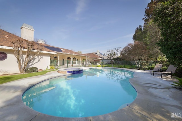 view of pool featuring an in ground hot tub and a patio