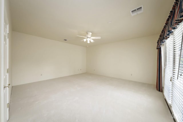 unfurnished bedroom with ceiling fan and light colored carpet