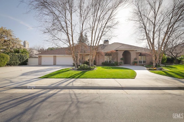 mediterranean / spanish house featuring a garage and a front yard