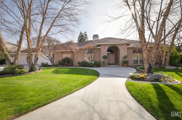 mediterranean / spanish-style home with a garage and a front yard