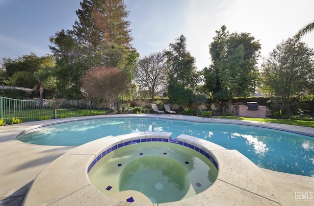 view of swimming pool featuring an in ground hot tub