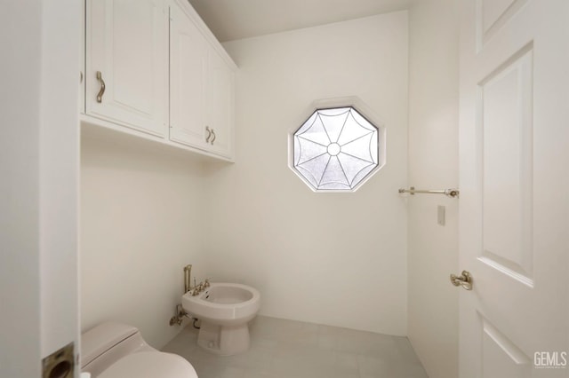 bathroom with a bidet and toilet