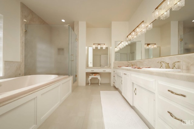 bathroom with independent shower and bath, vanity, and tasteful backsplash