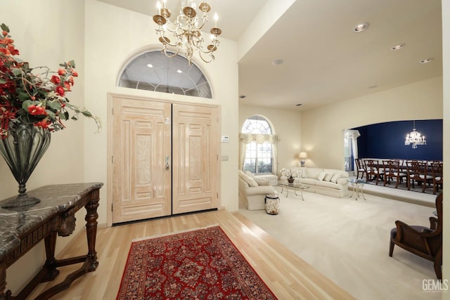 entrance foyer with a notable chandelier and light hardwood / wood-style flooring