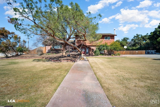 view of front facade with a front yard and fence