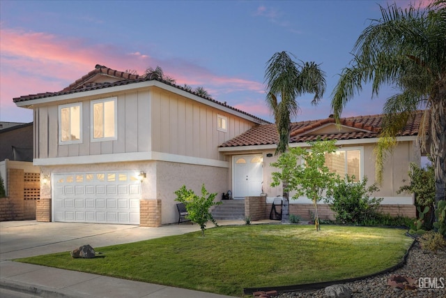 view of front facade with a garage and a lawn