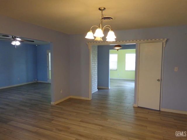 3001 Peach Tree Ct, Bakersfield, CA 93301 - spare room with baseboards, wood finished floors, visible vents, and ceiling fan with notable chandelier