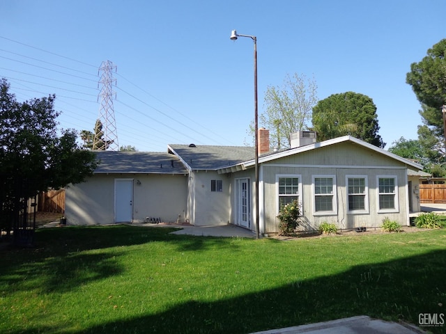 3001 Peach Tree Ct, Bakersfield, CA 93301 - back of property with a lawn, fence, and a chimney
