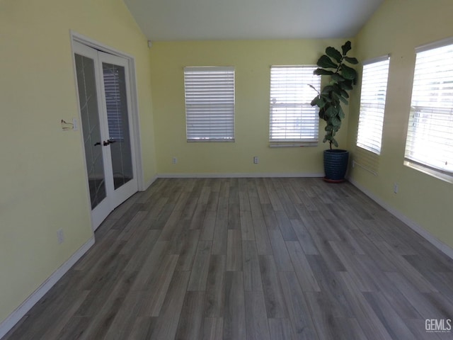 3001 Peach Tree Ct, Bakersfield, CA 93301 - spare room featuring vaulted ceiling, french doors, wood finished floors, and baseboards