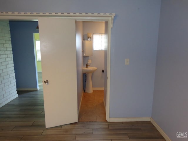 3001 Peach Tree Ct, Bakersfield, CA 93301 - hall featuring baseboards, wood finished floors, and a sink