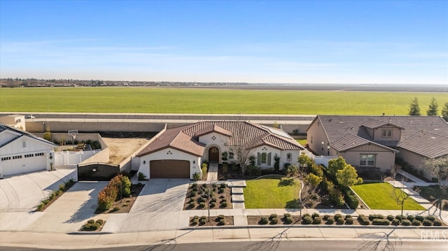 view of front facade with a rural view and a garage