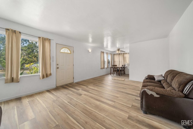 living room with ceiling fan and light hardwood / wood-style flooring