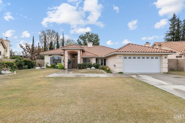 mediterranean / spanish-style home featuring a front yard and a garage