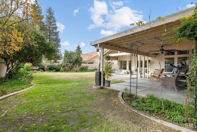 view of yard featuring a patio and ceiling fan