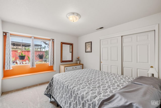 carpeted bedroom with a closet