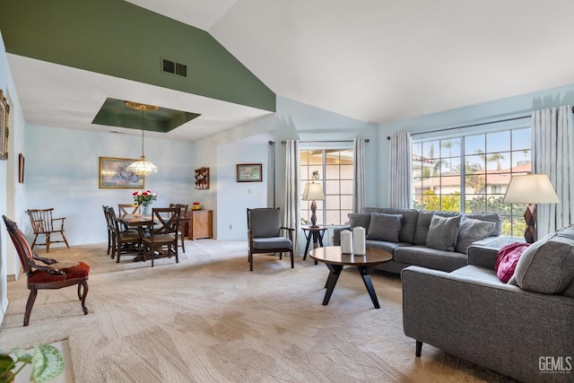 carpeted living room featuring vaulted ceiling