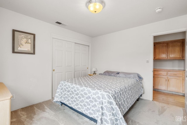 carpeted bedroom with a closet