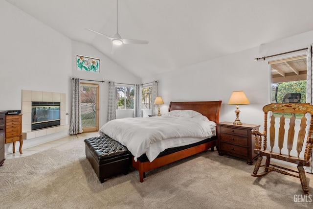 bedroom featuring ceiling fan, high vaulted ceiling, light colored carpet, access to outside, and a fireplace