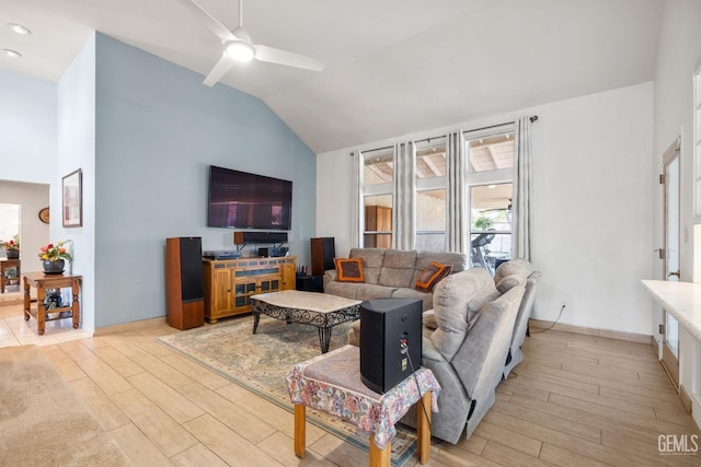 living room with ceiling fan, lofted ceiling, and light hardwood / wood-style flooring