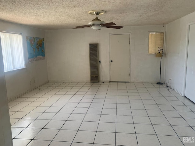1473 22nd Ave, Delano, CA 93215 - unfurnished room featuring a heating unit, a textured ceiling, and a ceiling fan