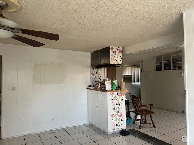 1473 22nd Ave, Delano, CA 93215 - interior space with a ceiling fan, a textured ceiling, and light tile patterned floors