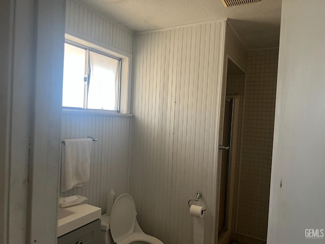 1473 22nd Ave, Delano, CA 93215 - full bath featuring vanity, toilet, a textured ceiling, and a shower