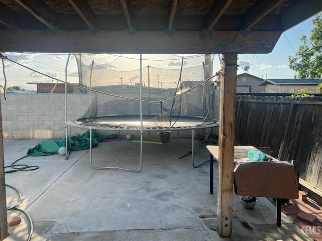 1473 22nd Ave, Delano, CA 93215 - view of patio with a fenced backyard and a trampoline