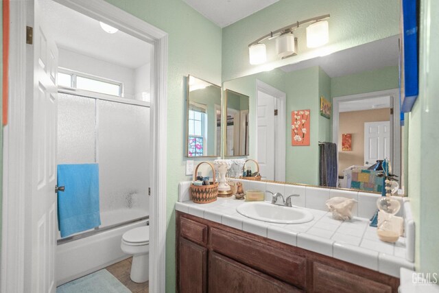 3809 Wensley Ct, Bakersfield, CA 93311 - full bath with toilet, vanity, shower / bath combination with glass door, and tile patterned flooring