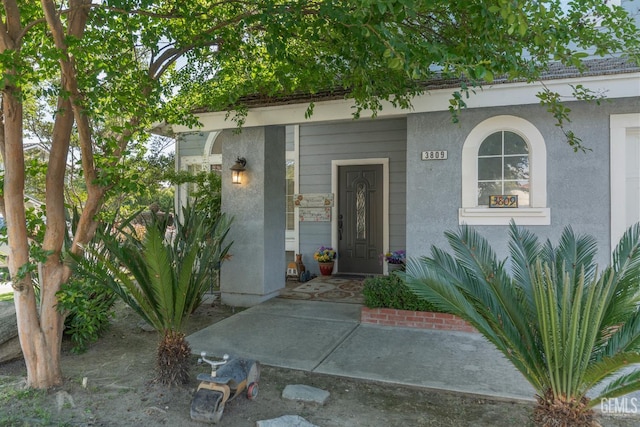 3809 Wensley Ct, Bakersfield, CA 93311 - view of exterior entry with stucco siding and covered porch