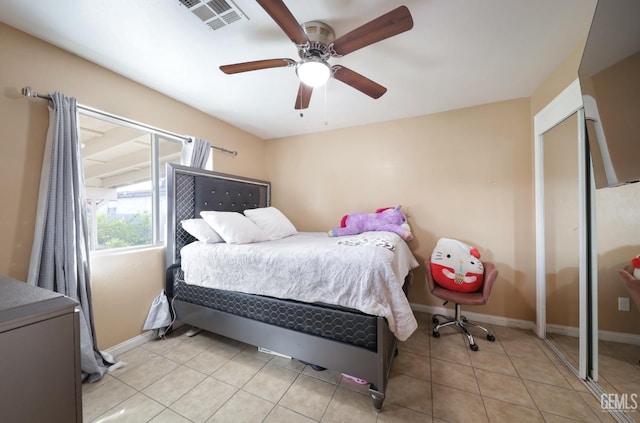 bedroom featuring light tile patterned floors and ceiling fan