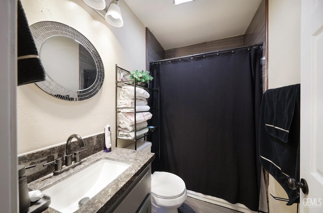 bathroom with vanity, a shower with curtain, and toilet