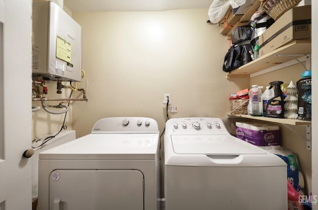 laundry room with water heater and independent washer and dryer