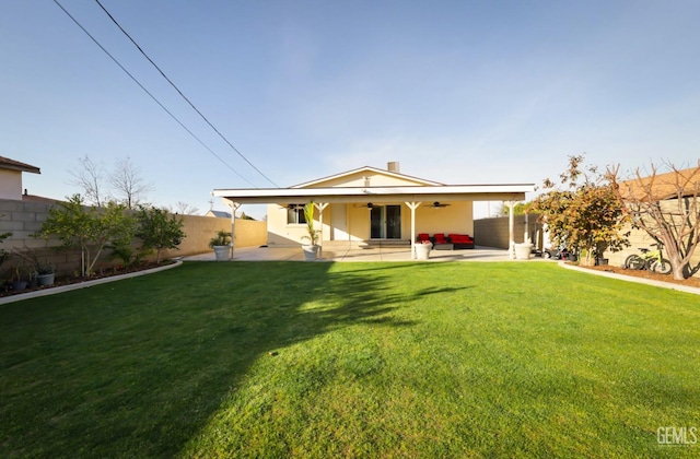 back of property with a patio and a lawn