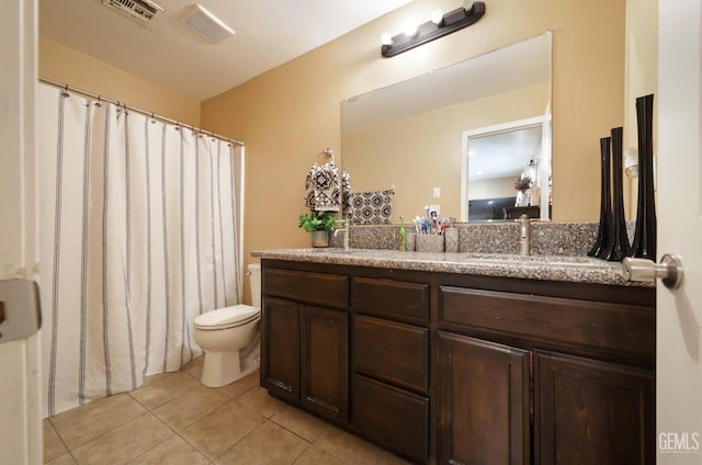 bathroom featuring vanity, toilet, and tile patterned flooring