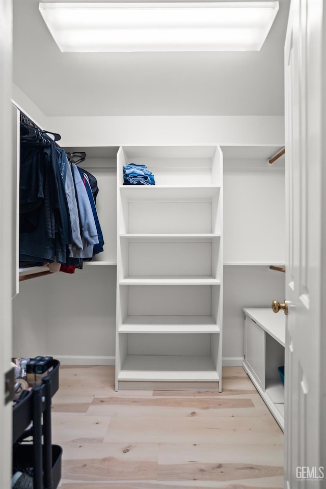 spacious closet featuring light hardwood / wood-style floors