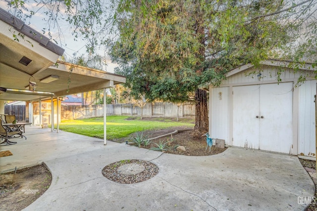 view of yard with a patio area and a storage unit