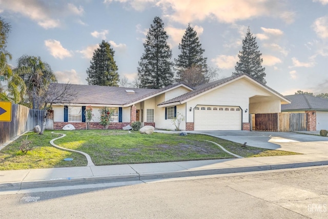 ranch-style home with a garage and a front lawn