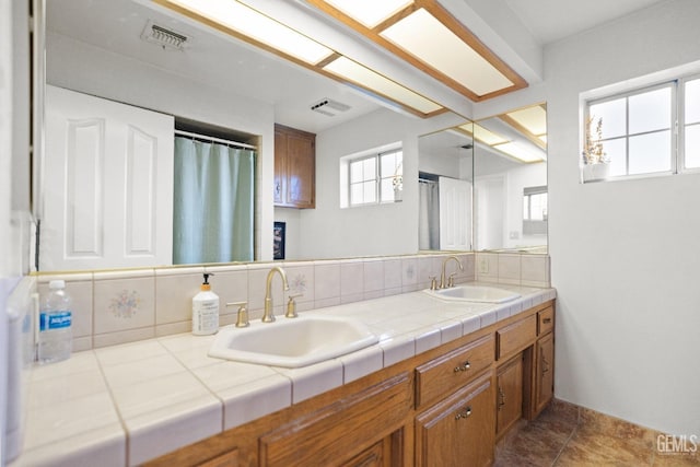 bathroom with tasteful backsplash and vanity