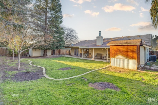 view of yard with central AC unit and a patio area